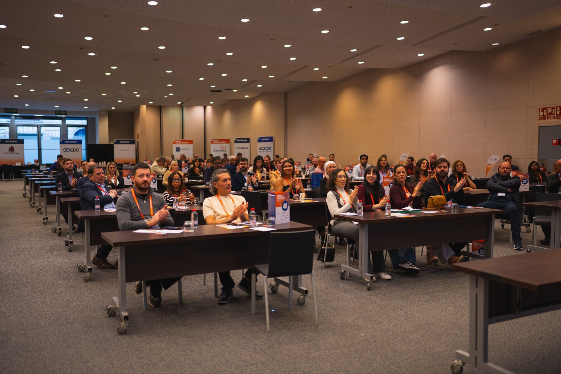 Delegates seated at tables during a session
